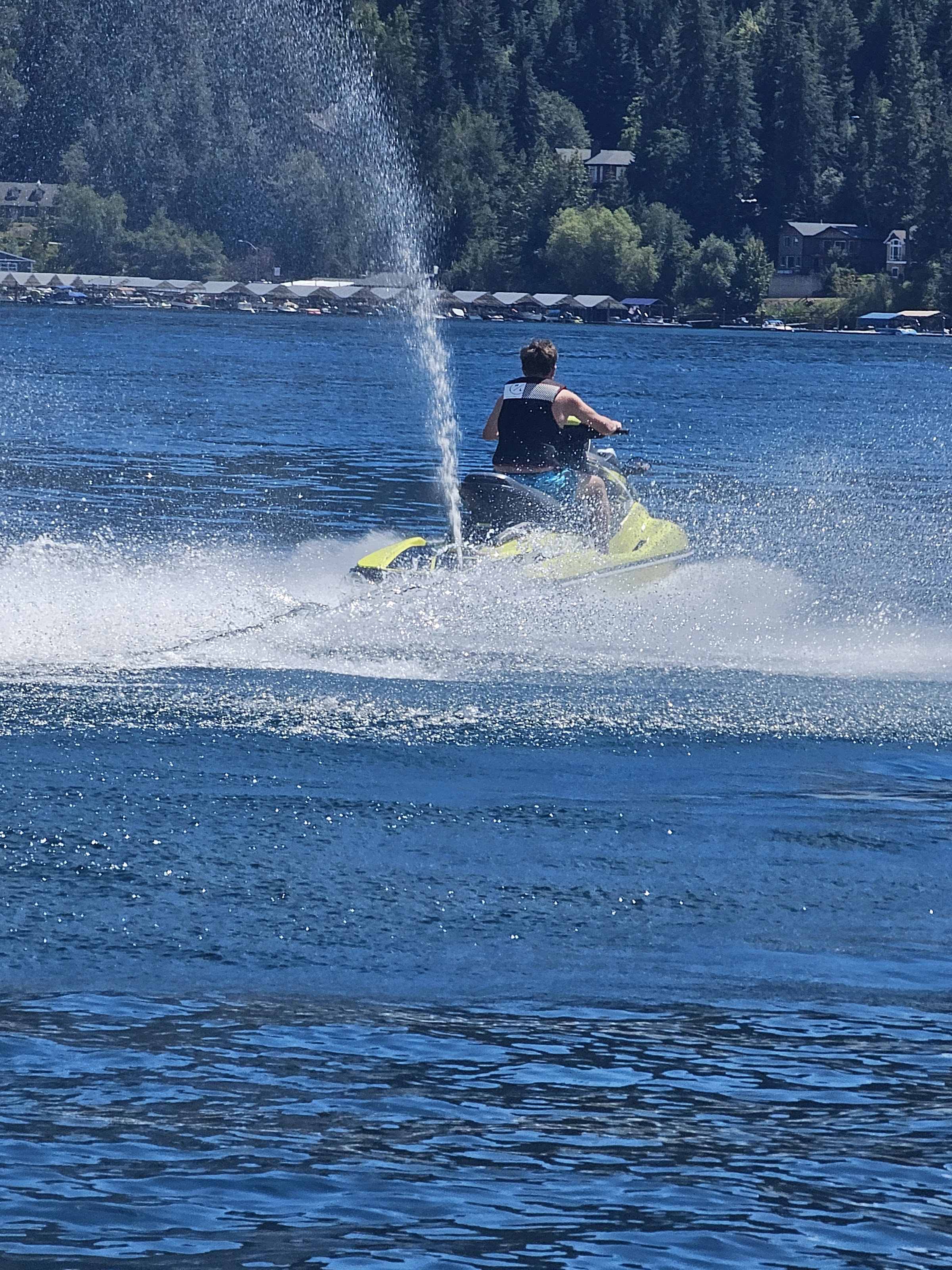 Rider on a jet ski cruising across a deep blue lake